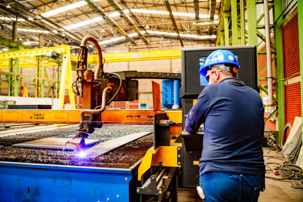 Steel worker on CNC plasma cutter machine